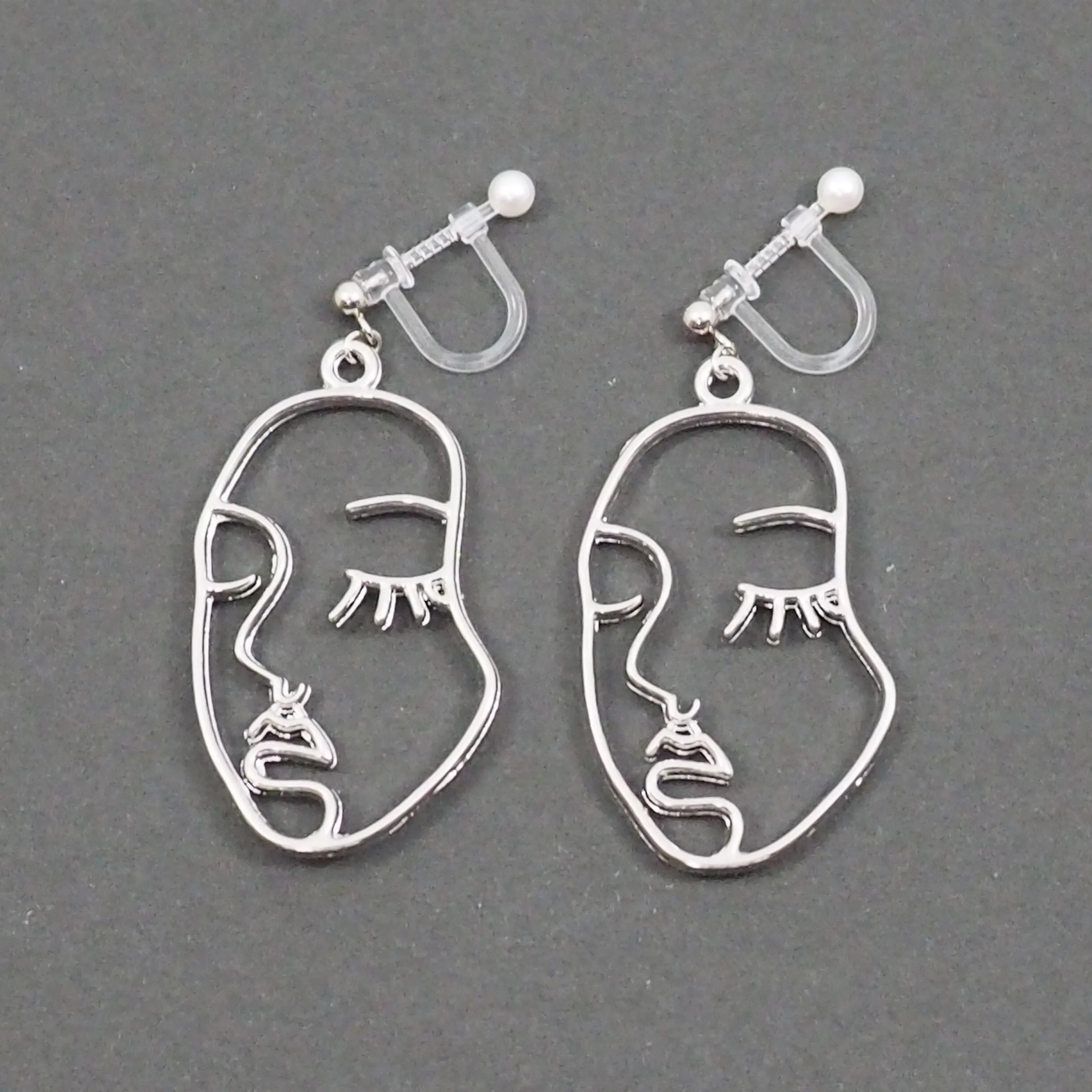 Silver Picasso Face Closed Eyes Invisible Clip On Earrings